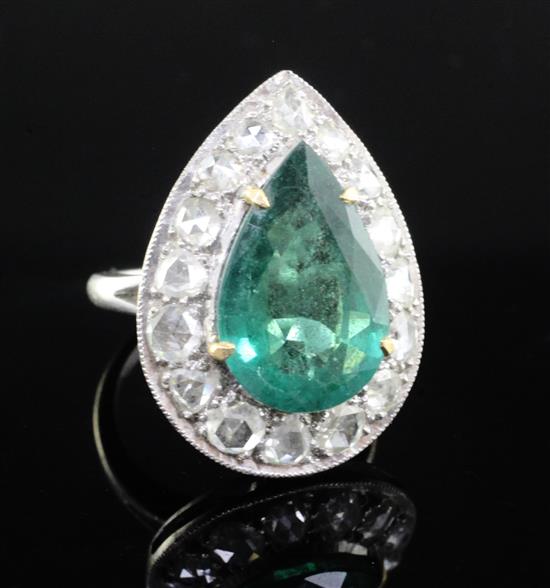 An 18ct white gold, emerald and diamond pear shaped dress ring, size N.
